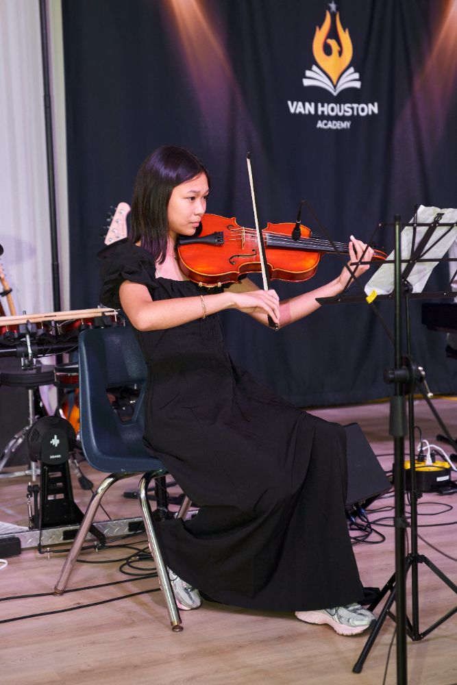 Van Houston Academy student performing violin in the Music Program